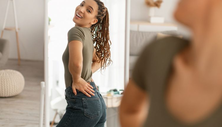 woman-standing-in-front-of-a-mirror-with-her-hands-on-her-hips